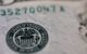 Close-up of an eagle emblem printed on a U.S. dollar bill, symbolizing American finance and economy.