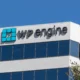 Modern WP Engine office building with sleek glass facade and vibrant company logo.