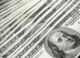 Stack of 100 US dollar banknotes arranged neatly, representing the $100 habit.